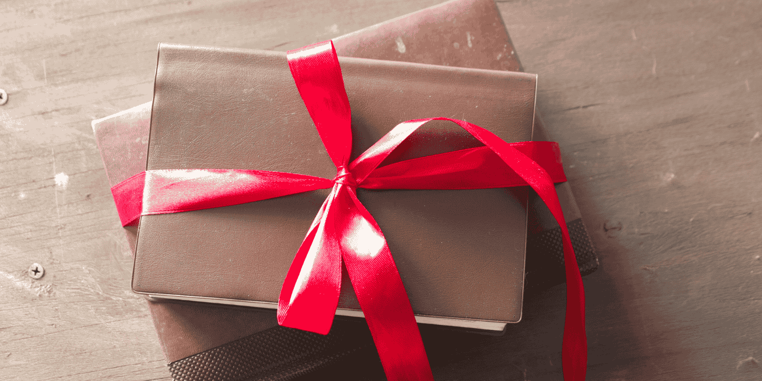 Stack of books tied with a red ribbon, symbolizing free book giveaways available through the Goodreads app.