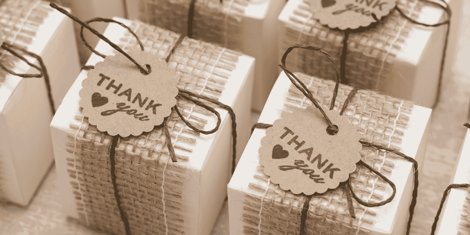 Elegant wedding-themed gift boxes tied with ribbons, arranged neatly on a table—representing the concept of "How to Make Wedding Giveaways"