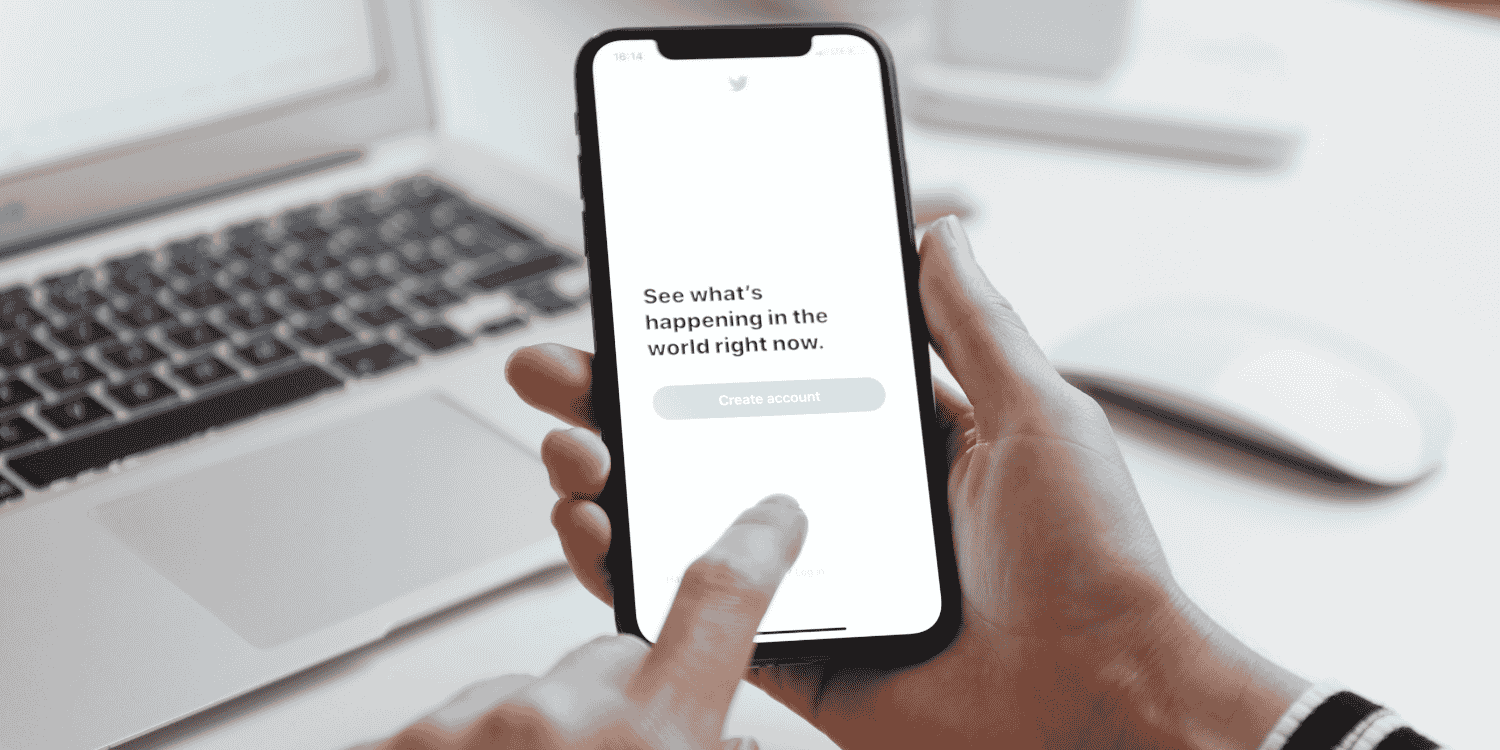 Person using a smartphone with the Twitter app open, preparing to create an account or engage, representing strategies for winning Twitter retweet giveaways.