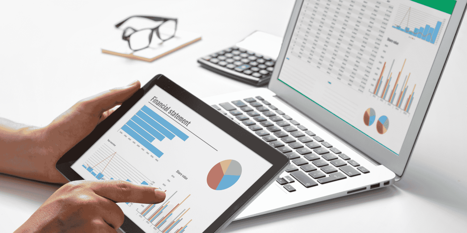Person analyzing financial and marketing performance charts on a tablet and laptop, representing how giveaways contribute to brand growth, customer engagement, and ROI.